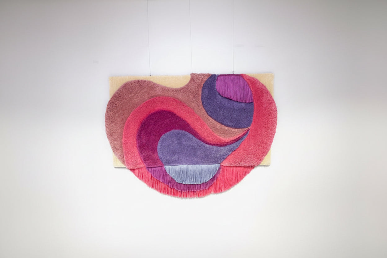 Colorful abstract rug with pink and purple swirls on a white background