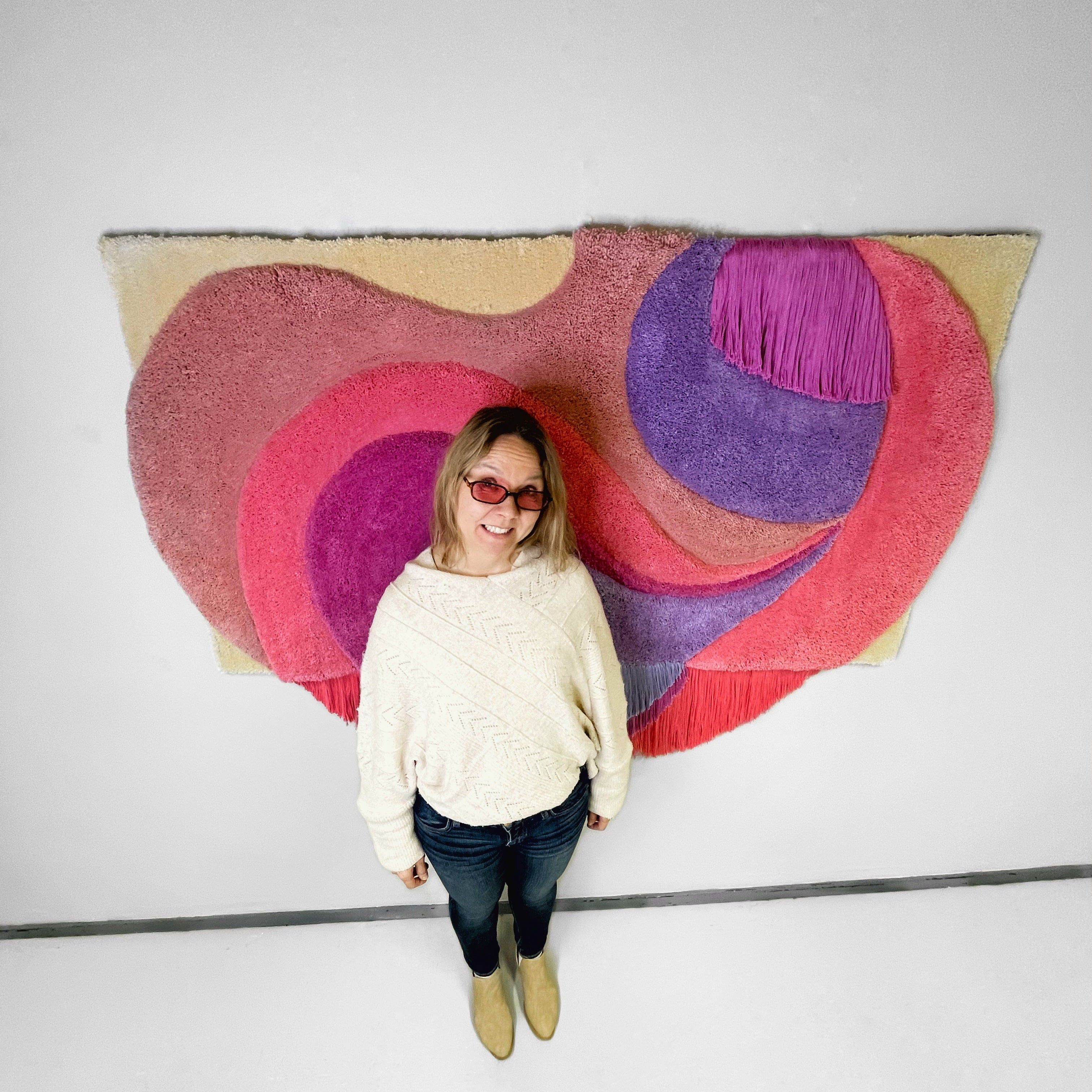 Paula standing in front of artwork